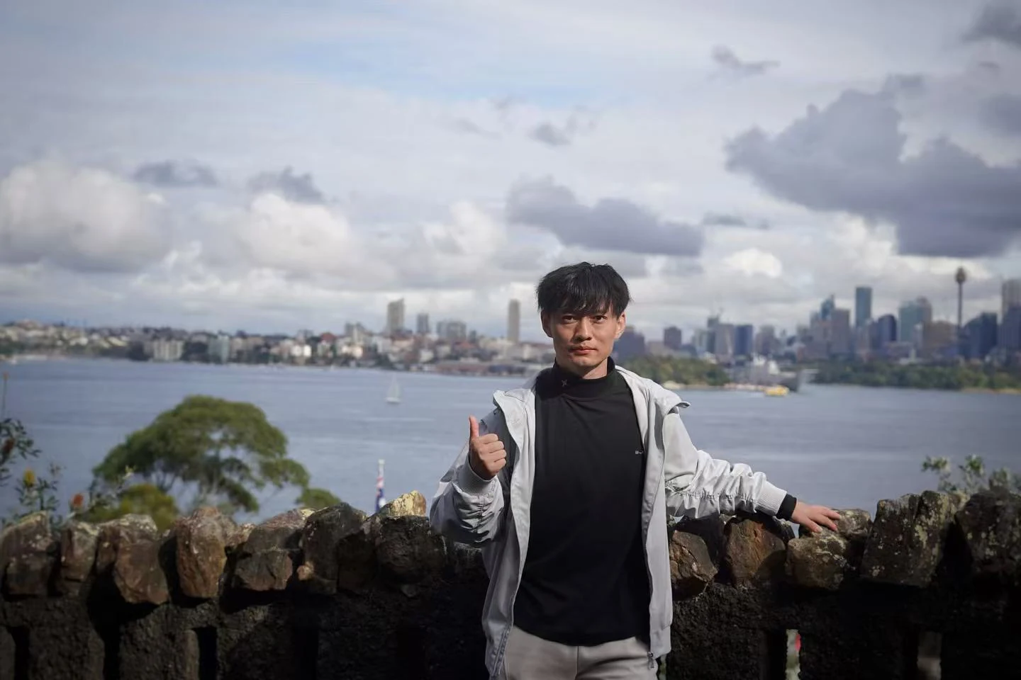 Portrait of Ren Yuxin overlooking a harbour skyline